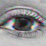 Close up shot of woman's eye with a glitch filter distorting the photo