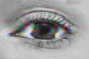 Close up shot of woman's eye with a glitch filter distorting the photo