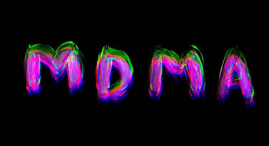 MDMA. painted on black paper background with glitch effects.
