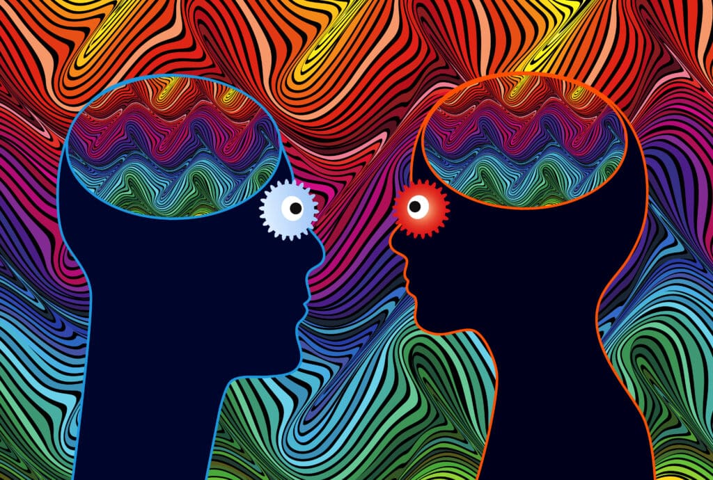 Abstract image of male and female portrait silhouette facing each other, with various psychedelic colours in the background.